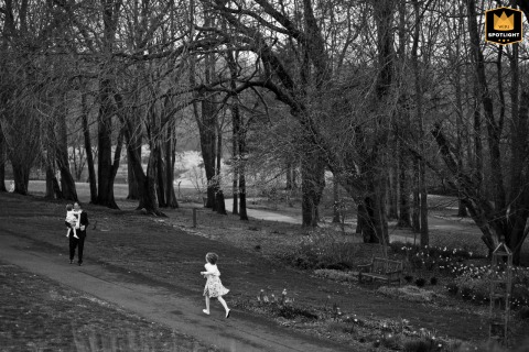   At Meadowlark Botanical Gardens in Vienna, Virginia, a girl sprints toward her father, who carries her wandering sister.
