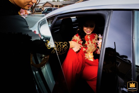   Intimate moments from pre wedding ceremony at a private residence in San Jose, California, reflect the emotional and meaningful moment the bride exits the car in all red.