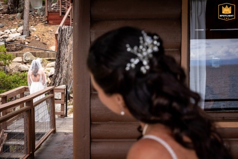 Bride Peeks Out Thoughtfully Before Her Entrance In South Lake Tahoe, California In South Lake Tahoe, California, a bride takes a quiet, reflective moment, peeking out with anticipation before making her entrance and stepping forward on her wedding day.