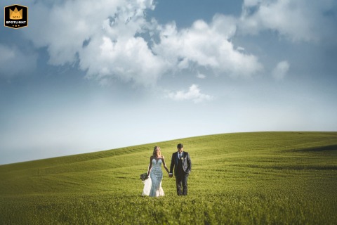 Set in the striking scenery of Crete Senesi, Tuscany, the couple enjoys a portrait together, their joy accentuated by the dramatic skies and open slopes of this legendary region.