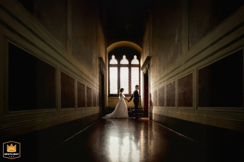 A romantic scene unfolds at Palazzo Pubblico in Siena, Tuscany, with the couple posing for a portrait surrounded by the rich history and elegance of the medieval building.