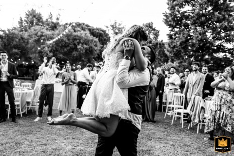Groom Lifts The Bride In A Joyful Dance During The Party At Tenuta La Lepre Italy During the start of the party at Tenuta la Lepre in Santarcangelo, Italy, the groom lifts the bride in a joyful dance, capturing candid celebration and the couple’s radiant happiness.