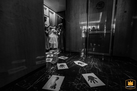 Bridesmaids at a hotel in Fujian, China, await their ride, their poised anticipation reflecting the excitement and camaraderie of the wedding morning preparations.