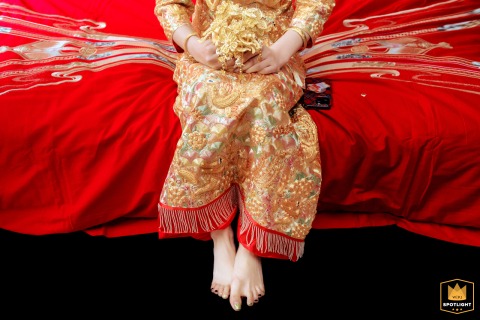 The bride’s toes curl with nervous anticipation in Kaifeng, China, a subtle yet telling detail of her excitement and emotion before the wedding ceremony.
