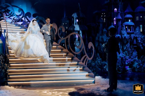 The groom waits with great anticipation in Kaifeng, China, as the bride and her father make their entrance, setting an emotional and touching scene at the ceremony.