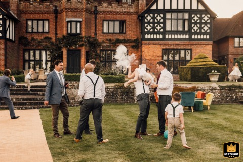 A flower girl is playfully lifted into the air in Sussex, UK, her movement aligning with a nearby vape smoke cloud to make it humorously appear as if she caused the puff of mist.