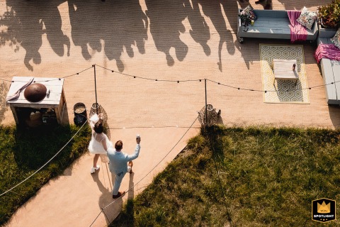 A unique bird’s-eye view in Wiltshire shows the bride and groom greeting guests, giving a lively, dynamic perspective of friends and loved ones celebrating together.