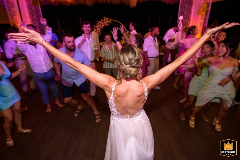 In Tulum, the bride enthusiastically welcomes her guests to the party, radiating excitement and inviting everyone to join the celebration under the vibrant Mexican sky.
