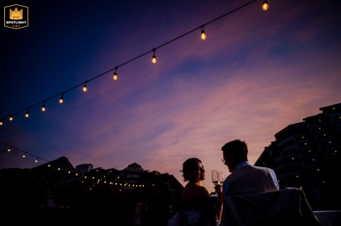 In Avignon, the bride and groom raise their glasses at sunset, toasting to their future as the fading golden light adds a magical glow to their celebratory cheer.