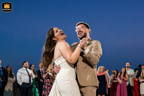 A couple sings joyfully and dances across the floor at Mount Vernon Canyon Club, CO, sharing lively energy and pure happiness during their memorable first dance.