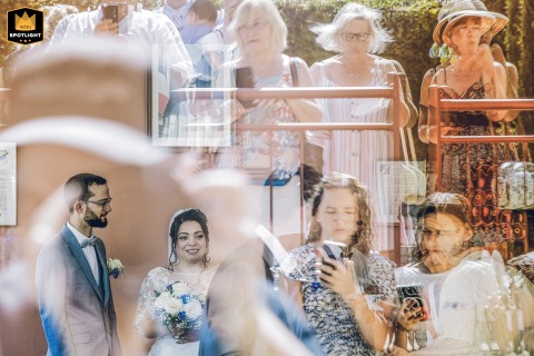 Creative Scene Setter Of Reflections Showing Guests And The Couple In Saint Nexans France At the town hall of Saint-Nexans in Dordogne, France, clever reflections reveal both the waiting guests and the bride and groom, creative composition enhancing the excitement.