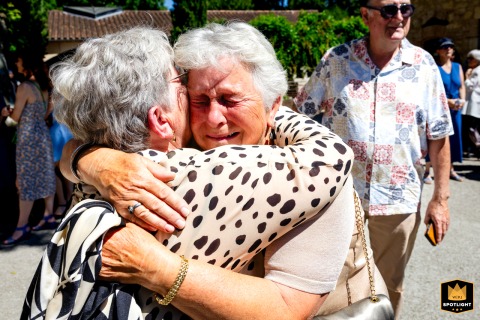 Outside the village town hall in Tarn-et-Garonne, both mothers of the newlyweds share tears and embrace, touched by the deep emotions of the wedding day.