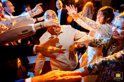 Captured at Chez Ernest, a renowned restaurant in Tarn-et-Garonne, an exuberant wedding guest radiates pure joy during a festive moment at the marriage reception.