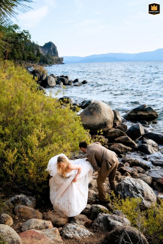 In South Lake Tahoe, CA, the newlyweds carefully climb over rocks, surrounded by wild natural beauty, beginning their adventure into married life in the mountain landscape.