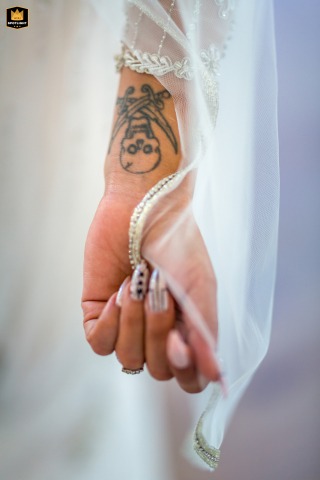   In Camarillo, CA, a bride's veil delicately frames her tattoo, merging traditional wedding elegance with her own personal and unique style.