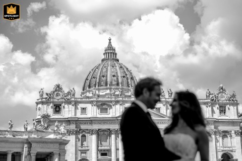 Bathed in the grandeur of Vatican City, the couple pauses for a portrait in Saint Peter Square, the iconic architecture of Rome lending majesty to their wedding day.