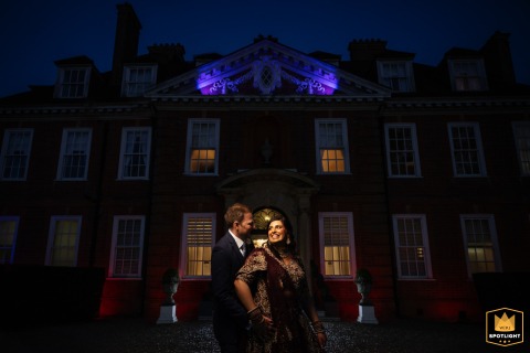 Evening falls at Hunton Park, where the venue’s beautifully lit exterior serves as the scene for a striking nighttime portrait of the newlyweds.