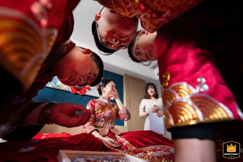 Lively energy fills a Shanxi hotel where groomsmen enthusiastically participate in gate-crashing games, adding humor and friendly competition to the day’s events.