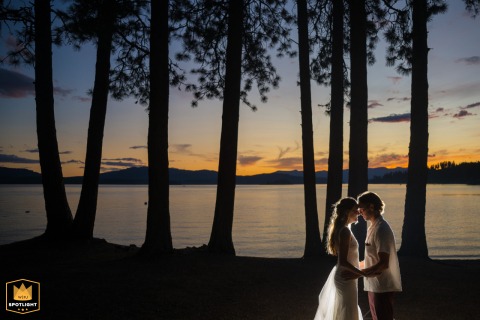 The Happy Couple Celebrates Their New Marriage At The Scenic Beyond Hope Resort In Idaho The happy bride and groom stand together celebrating their new marriage at the scenic Beyond Hope Resort in Idaho, surrounded by the stunning natural beauty of the area.