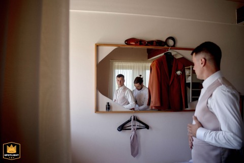 The Groom Focuses On Final Details Within The Historic Walls Of Château Chapeau Cornu France Within the historic walls of Château Chapeau Cornu, France, the groom focuses on his final getting ready details before heading out to meet his bride for the ceremony.