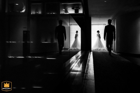 Striking Silhouettes Of The Couple Are Captured Within The Elegant Heritage Home Architecture In Bangkok A striking silhouette of the bride and groom is captured in the elegant architecture of the Nai Lert Park Heritage Home in Bangkok.