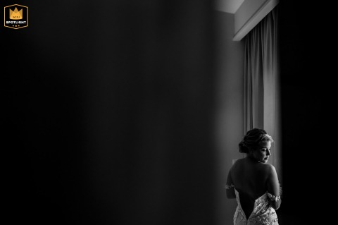 Natural Light Illuminates The Silhouette Of An Elegant Bride Preparing For Her Wedding In Avignon France An elegant bride stands gracefully by a window in Avignon, Vaucluse, as the natural light illuminates her silhouette during her wedding day preparations in the beautiful south of France.