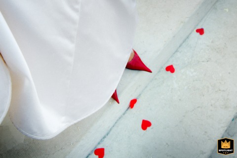 A detailed close-up shot captures the bride’s elegant shoes as she makes her joyful exit from the historic Basilica San Andrea in Mantova, Italy, following the wedding ceremony.
