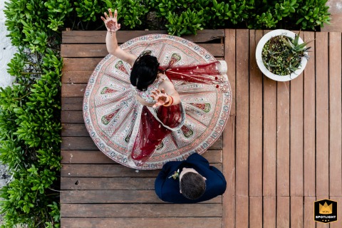In Tulum, Mexico, the groom spins the bride in a dance, the motion captured from above as her dress fans out in a circle, creating a dynamic image full of movement and celebratory energy.