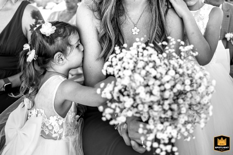 A Young Girl Hugs Her Mother Tightly Amid Festivities At Château Chapeau Cornu In France At Château Chapeau Cornu in France, a young girl hugs her mother tightly during the wedding celebration, capturing a moment of affection and warmth amidst the festivities at the historic French castle venue.