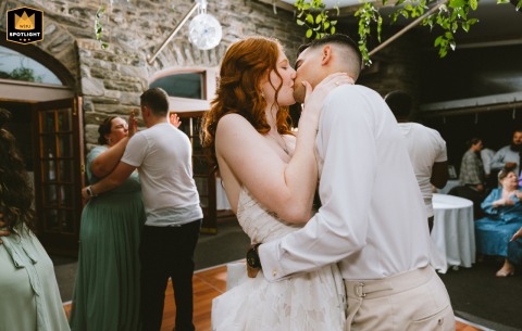 At a private garden wedding venue in Philadelphia, Pennsylvania, the couple shares a passionate kiss on the dance floor, surrounded by the motion and energy of the celebration.