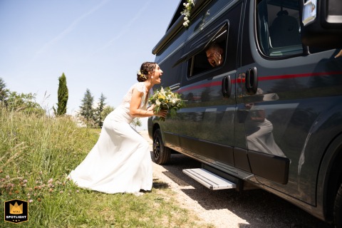 At Domaine de l'Ermitage, the bride catches her first glimpse of the groom just before the ceremony, sharing an emotional and anticipatory moment before they walk down the aisle.