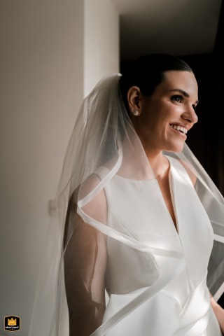 A smiling bride is captured in a vertical-format wedding portrait in São Paulo, Brazil, highlighting her joy and confidence as she prepares to celebrate her wedding day.