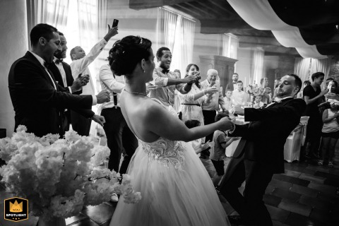 The newlyweds share their first dance at the Castle of Monbazillac in France, surrounded by an energetic atmosphere as guests celebrate and the reception comes alive around them.