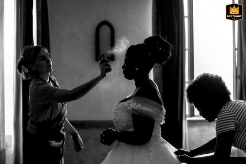 Bride Receives Final Makeup Touches At Château De Montalieu In France At Château de Montalieu, France, the bride receives a final touch of setting spray, completing the last preparations before making her way to the ceremony.