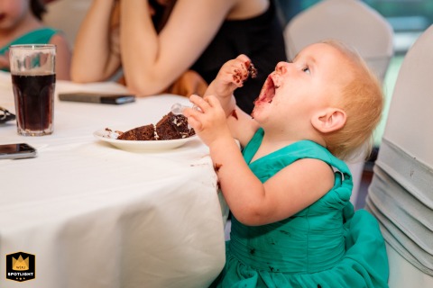 A young wedding guest enjoys a rich chocolate cake at the reception venue in Melbourne, Victoria, Australia, savoring a sweet highlight of the celebration.