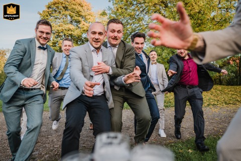 The groom and his groomsmen race toward the beer at Schloss Heeren in Kamen, Germany, turning a wedding-day tradition into a playful competition.