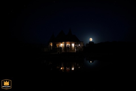 In Dordogne, France, the newlyweds watch the moonrise above their royal suite, enjoying a quiet romantic pause as evening settles over the elegant setting.