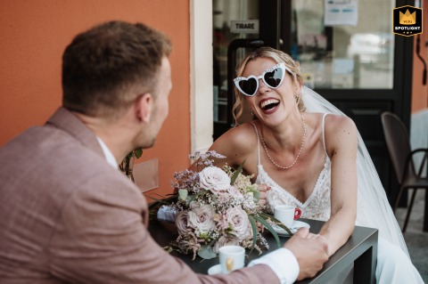 After the ceremony in Murazzano, Langhe, the couple share a coffee together outside, pausing for a quiet, everyday moment amid the wedding celebration there.