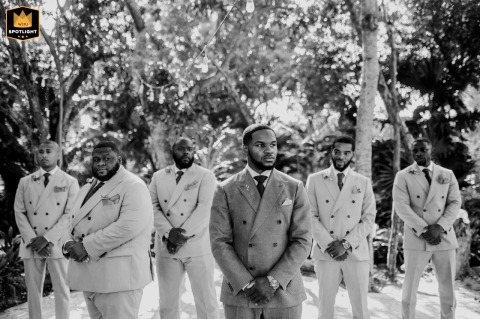 BW portrait of the man crew in Playa del Carmen gathered together, adding a social, celebratory feel to the wedding day with friends sharing the experience up close.