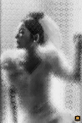 A Fujian bride's portrait appears behind glass at the hotel, using reflections to frame her elegant expression with a soft, dreamy quality before the celebration begins.