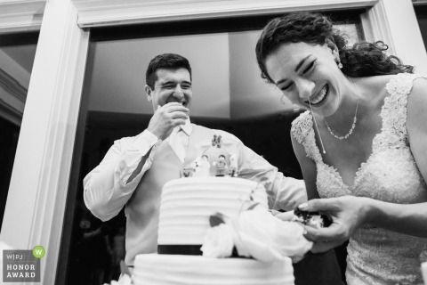 Purcellville bride and groom laugh as they eat the cake 