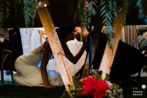Kiss under the table - Valencia Spain bride and groom during their reception
