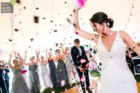 Kingston Ontario reception venue photo from the dance floor: The groom pops confetti bottle 