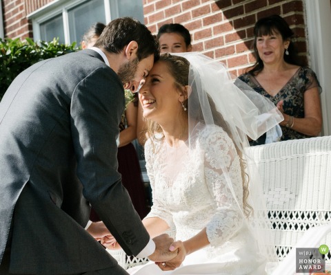 New York wedding photo from Long Island as The bride and groom put their foreheads together joyfully after seeing each other for the first time on their wedding day during the b'deken