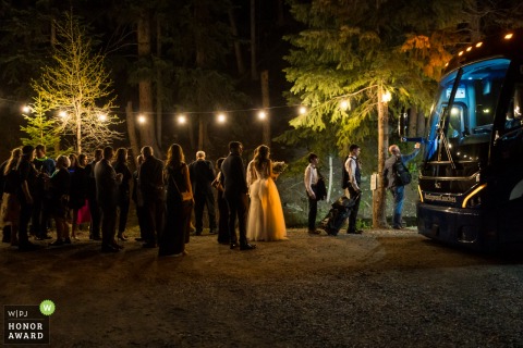 Colorado wedding photography contest award winning gallery picture from the outdoor Reception venue at the end of the night as guests are boarding the party bus 