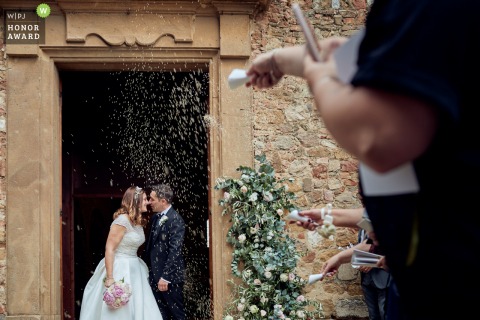 Tuscany wedding photographer contest award winning image sample from the Ceremony Location of confetti tossing