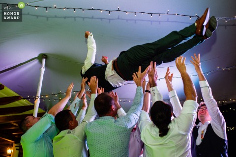 The Bulgaria WPJA is proud to award this non traditional Goliama Zheliazna wedding picture at Raiski Zaliv event venue showing the Tossing of the groom