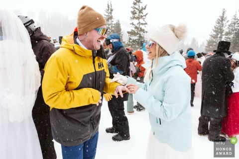 At Loveland Ski Area, a couple exchanges rings during a group ceremony in the snow at the ski resort.