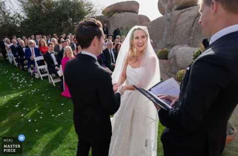 At Boulders Resort & Spa, an outdoor wedding ceremony takes place amid stunning natural rock formations and desert landscape scenery.