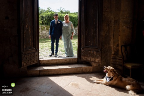 The groom arrives at Pieve di Ponte allo Spino in Siena, with anticipation building for the ceremony at this picturesque church in Tuscany.